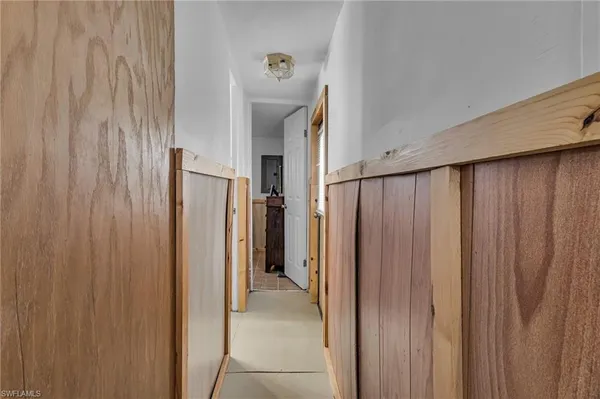 a view of a hallway with a refrigerator