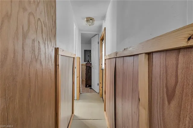 a view of a hallway with a refrigerator