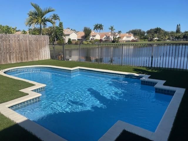 a view of a backyard with swimming pool