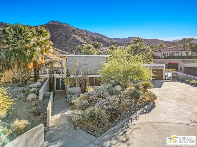 a view of a house with a yard and garage