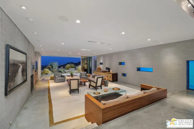 a living room with lots of furniture and kitchen view