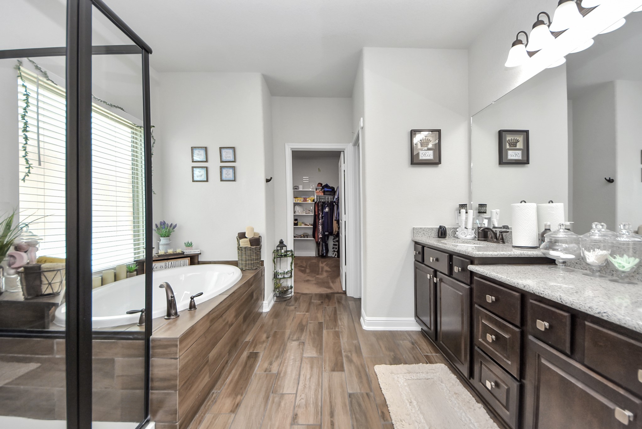 24503 Eucalyptus Way Spring, TX 77373 - Photo 7 of 27 a spacious en suite bathroom with a granite countertop tub sink and mirror