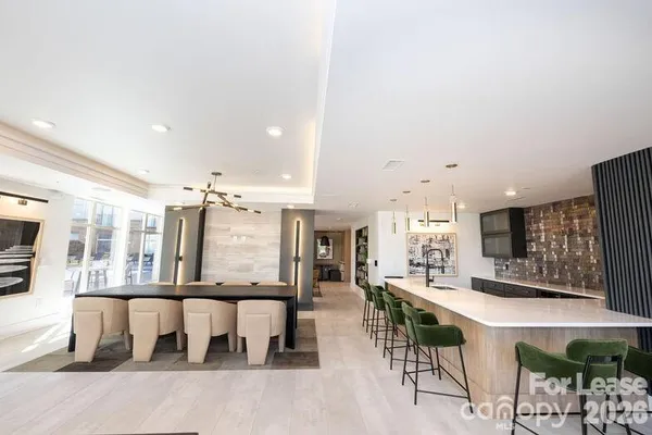 a large kitchen with a table and chairs