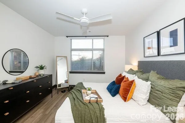 a bedroom with a bed window and a table