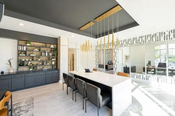 a large kitchen with a table and chairs