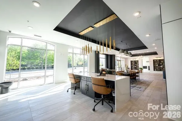 a view of a work space with furniture and a large window