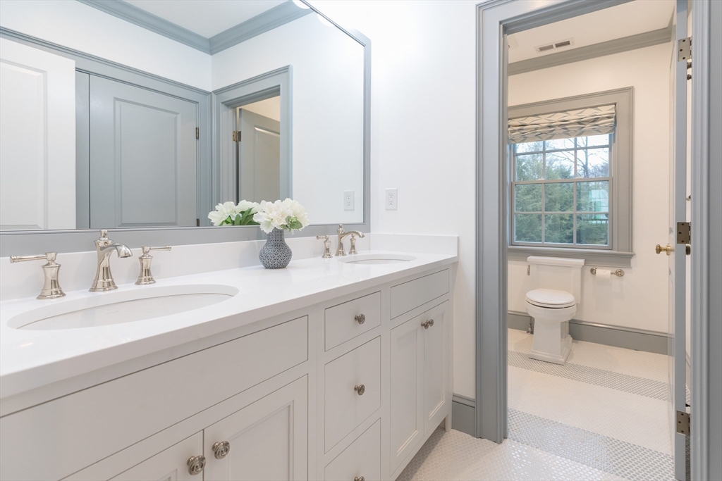 34 Chesterton Road Wellesley, MA 02481 - Photo 24 of 36 a bathroom with a granite countertop sink a toilet and a large mirror