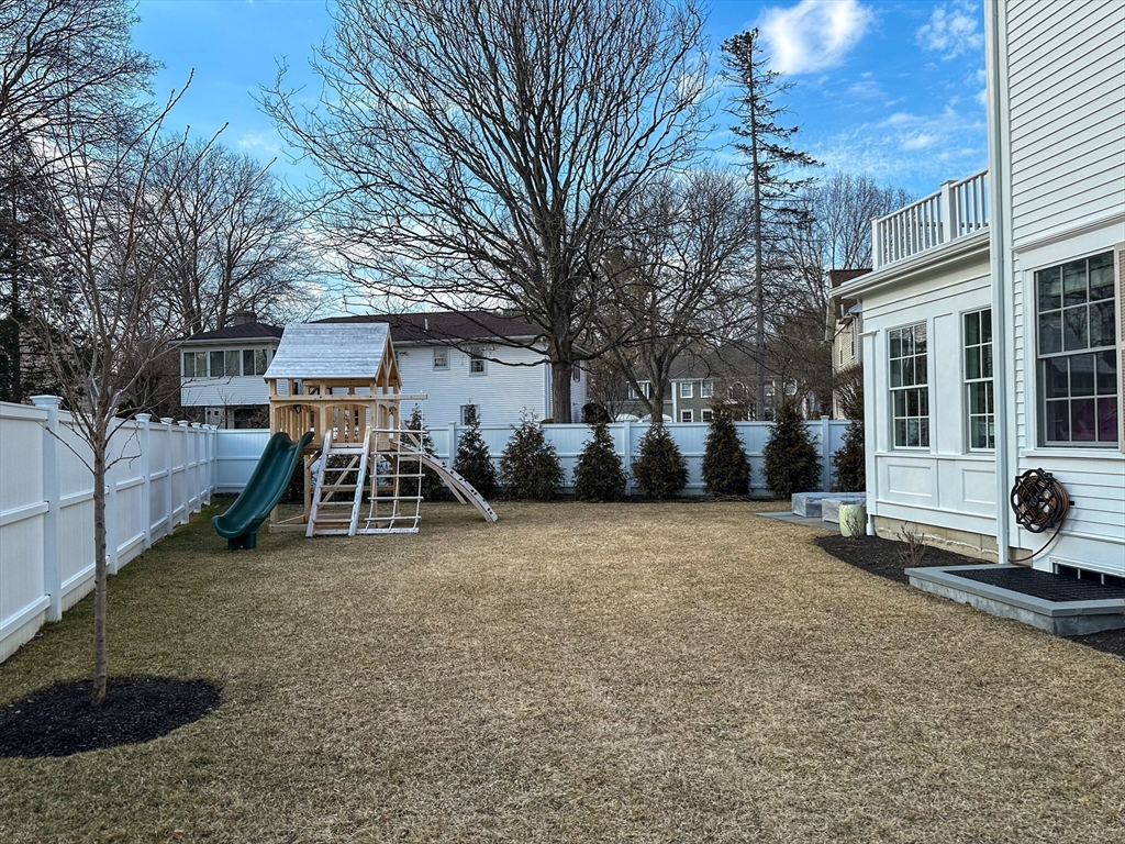 34 Chesterton Road Wellesley, MA 02481 - Photo 35 of 36 a view of a house with a patio and a yard