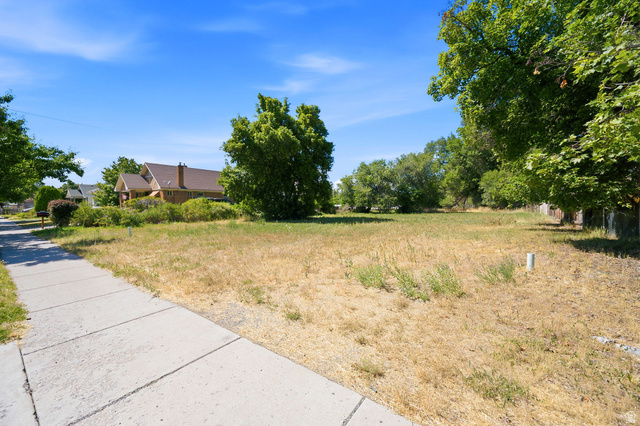 300 East S, Unit 2 Logan, UT 84321 - Photo 26 of 38 Expansive lot featuring mature trees along the perimeter and a paved sidewalk