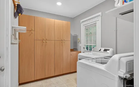 a view of washer and dryer with kitchen in the background