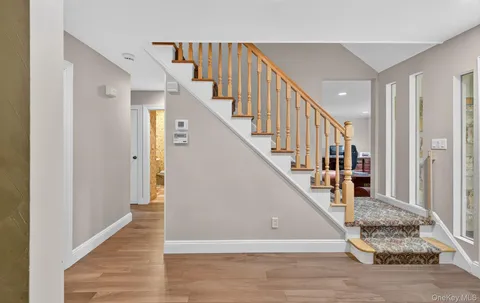 a view of entryway and hall with wooden floor