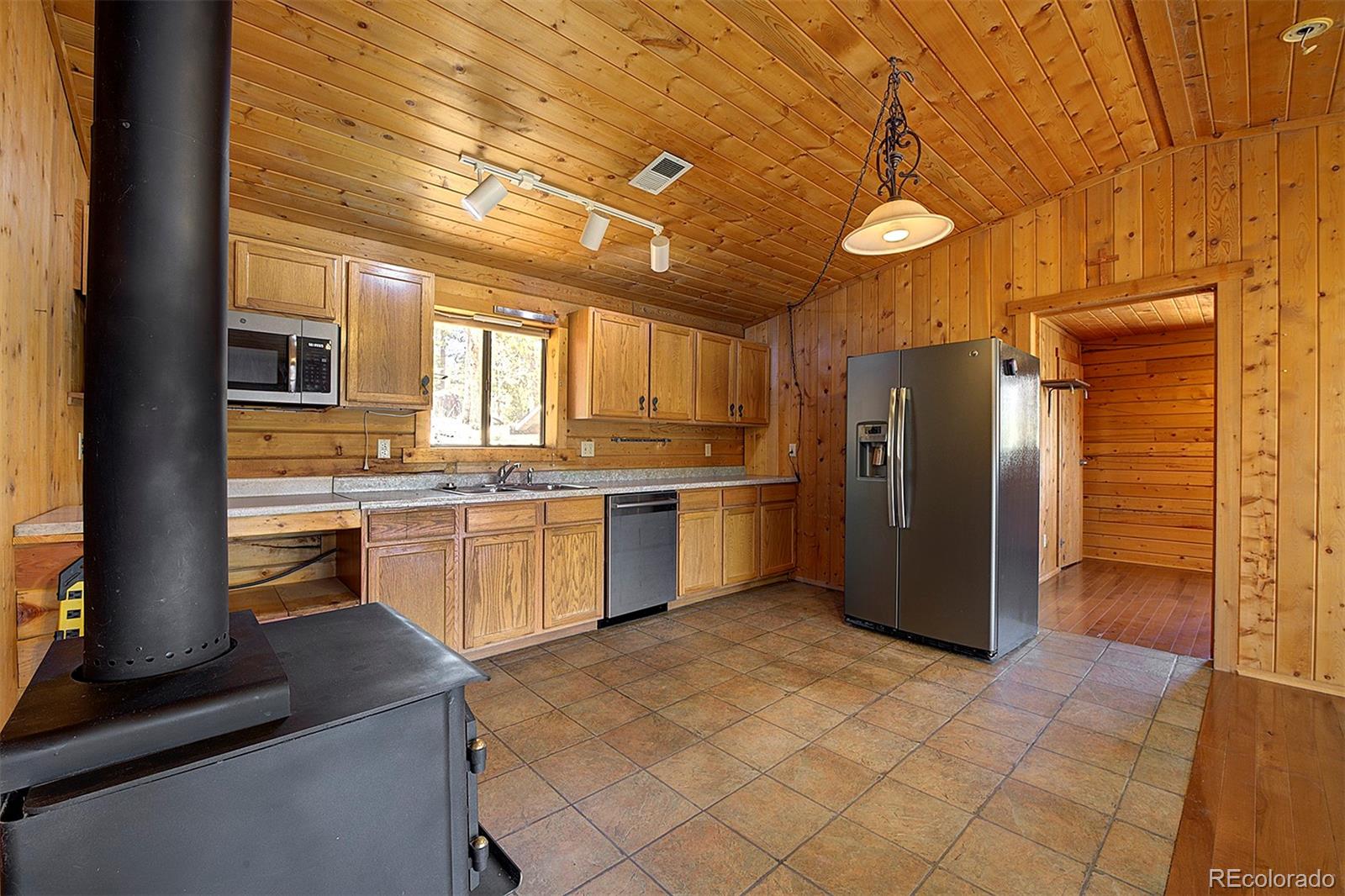 1536 Clark Road Bailey, CO 80421 - Photo 11 of 33 a kitchen with a refrigerator sink and stove