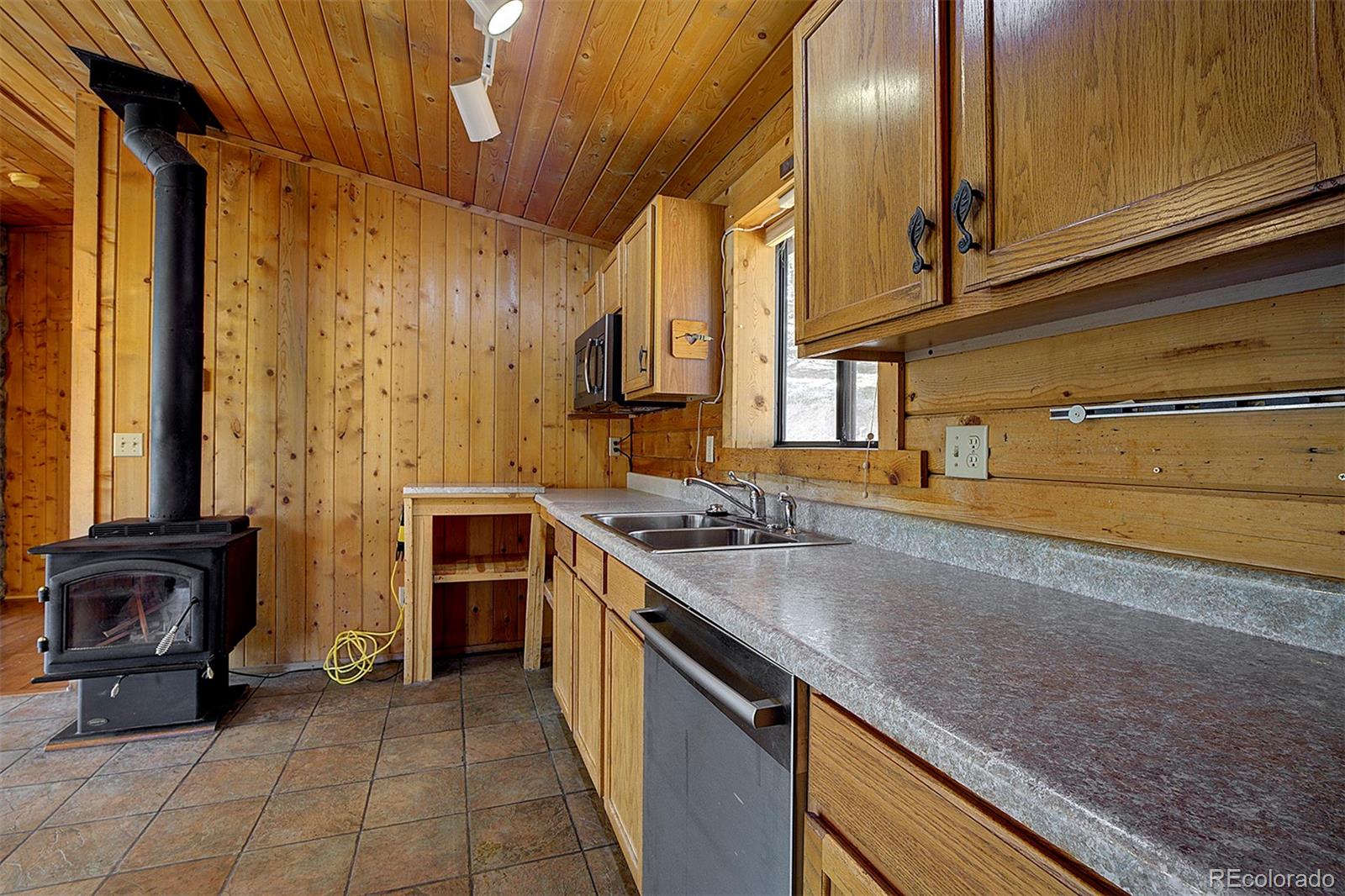 1536 Clark Road Bailey, CO 80421 - Photo 12 of 33 a kitchen with stainless steel appliances granite countertop a sink and a stove