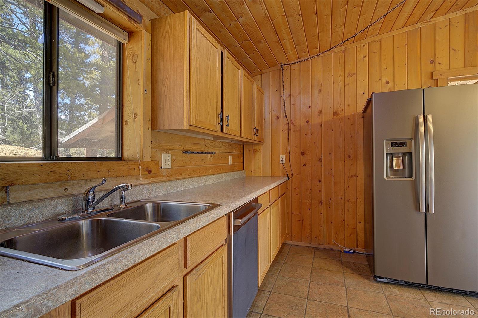 1536 Clark Road Bailey, CO 80421 - Photo 13 of 33 a kitchen with stainless steel appliances granite countertop a refrigerator and a sink