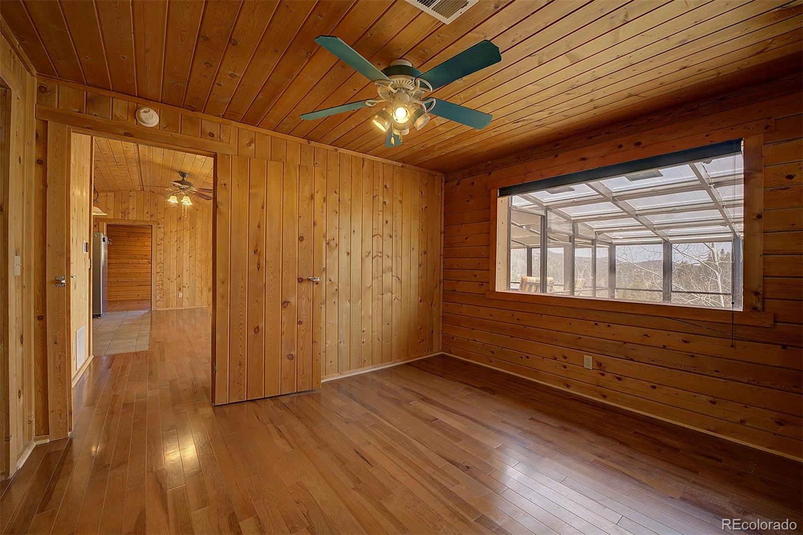 1536 Clark Road Bailey, CO 80421 - Photo 15 of 33 a view of an empty room with wooden floor and a window