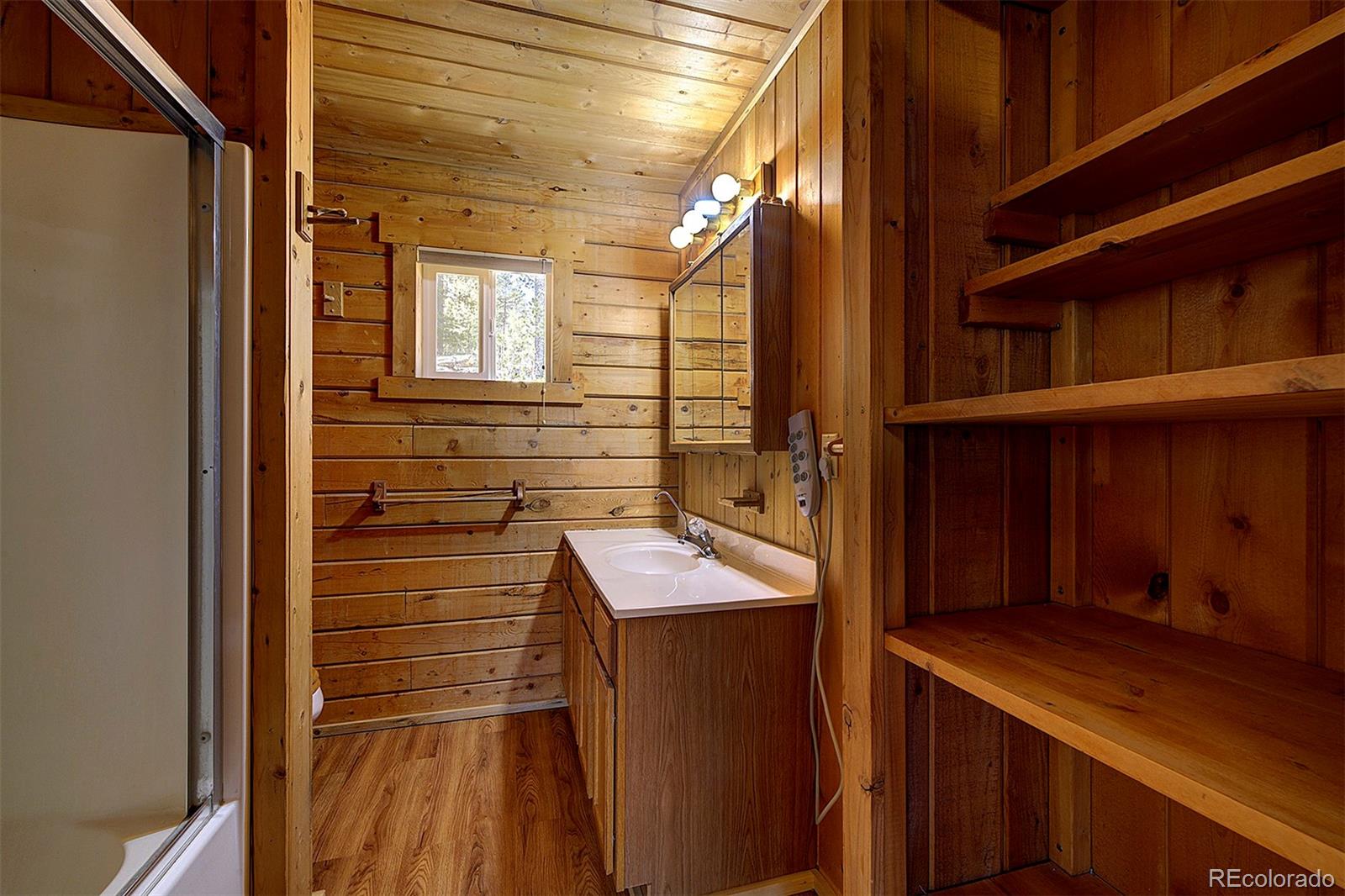 1536 Clark Road Bailey, CO 80421 - Photo 17 of 33 a bathroom with a sink and a mirror