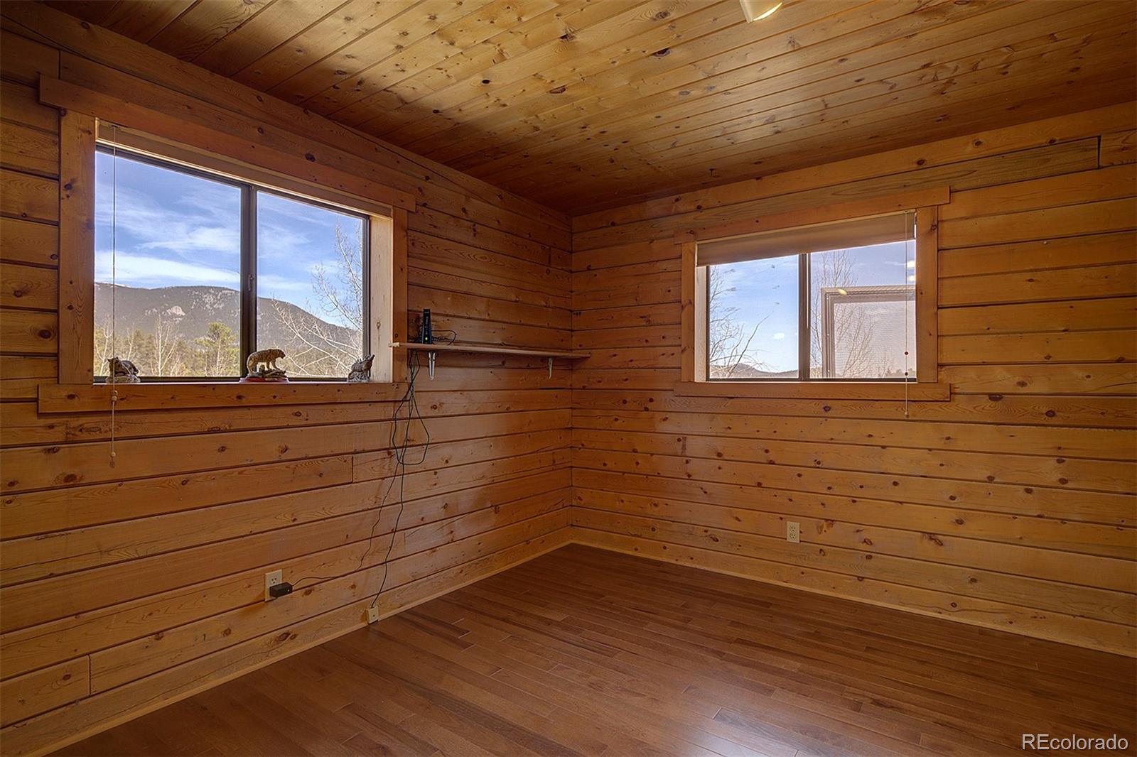 1536 Clark Road Bailey, CO 80421 - Photo 19 of 33 a view of empty room with wooden floor and fan