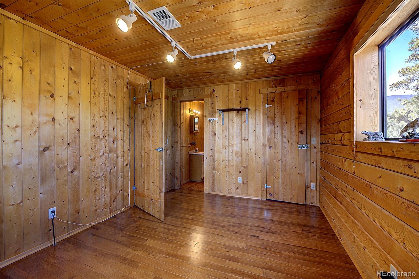 1536 Clark Road Bailey, CO 80421 - Photo 20 of 33 a view of empty room with wooden floor and fan