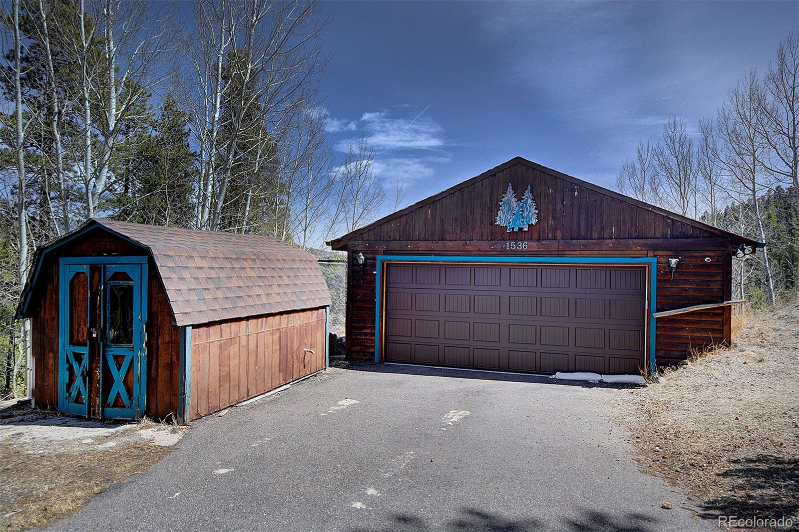 1536 Clark Road Bailey, CO 80421 - Photo 24 of 33 a front view of a house with a garage
