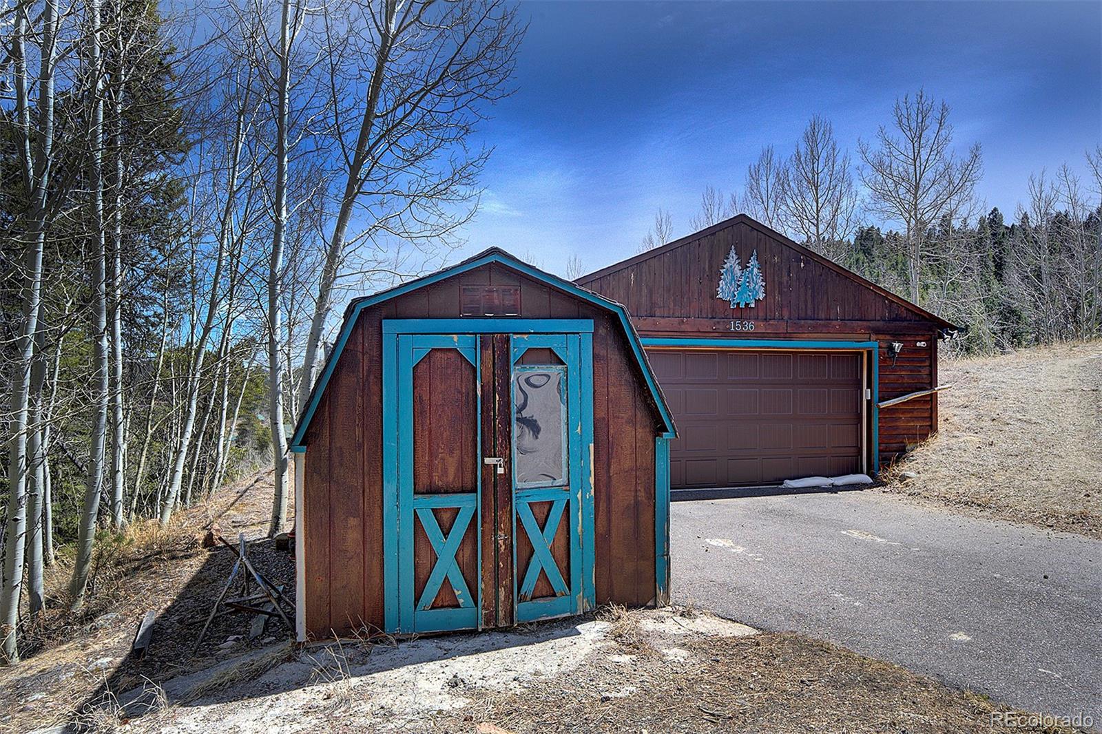 1536 Clark Road Bailey, CO 80421 - Photo 30 of 33 a front view of a house with garden