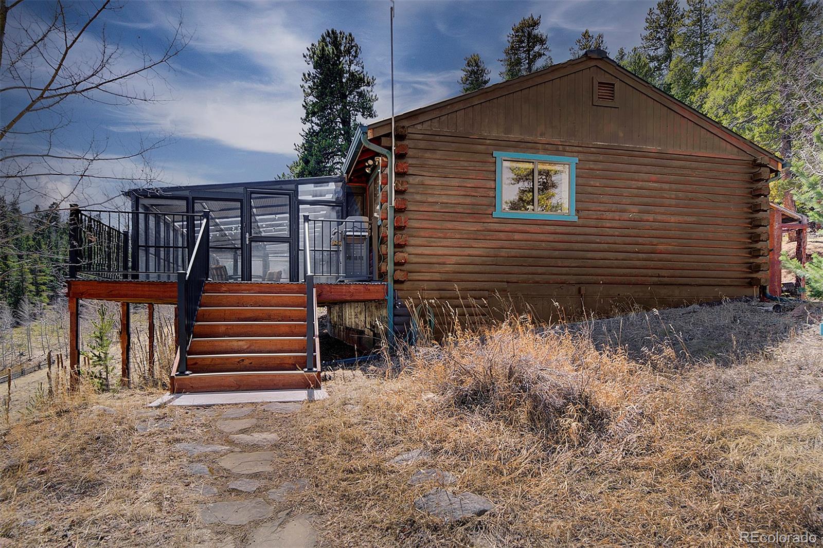 1536 Clark Road Bailey, CO 80421 - Photo 3 of 33 a view of a house with a yard and wooden floor and fence