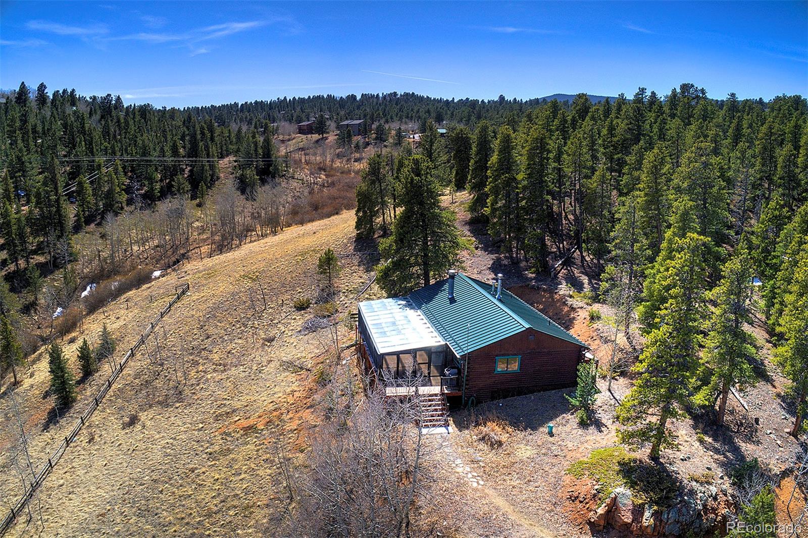 1536 Clark Road Bailey, CO 80421 - Photo 31 of 33 a view of a terrace with a yard