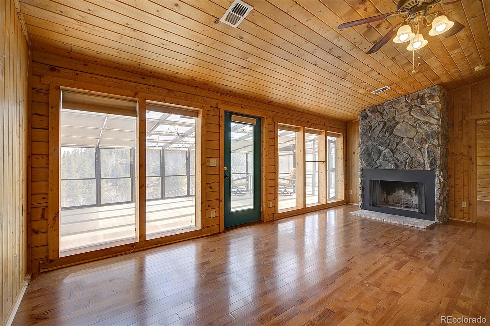 1536 Clark Road Bailey, CO 80421 - Photo 9 of 33 a view of an empty room with wooden floor and a window