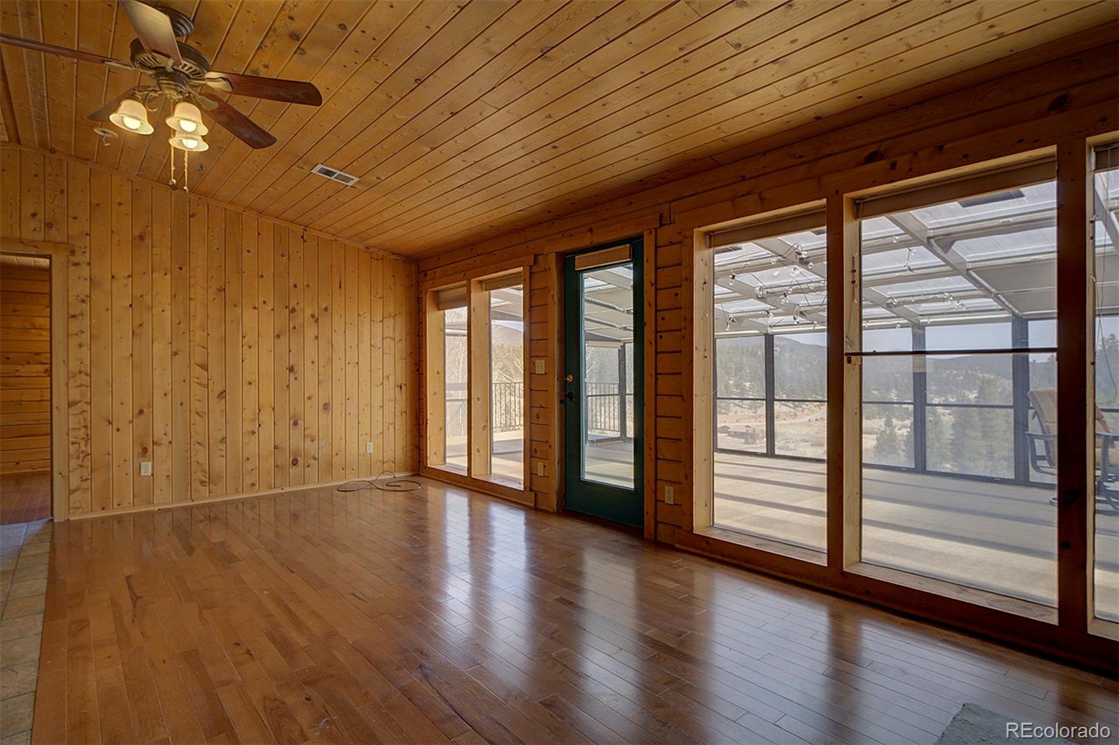 1536 Clark Road Bailey, CO 80421 - Photo 10 of 33 a view of an empty room with wooden floor and fan
