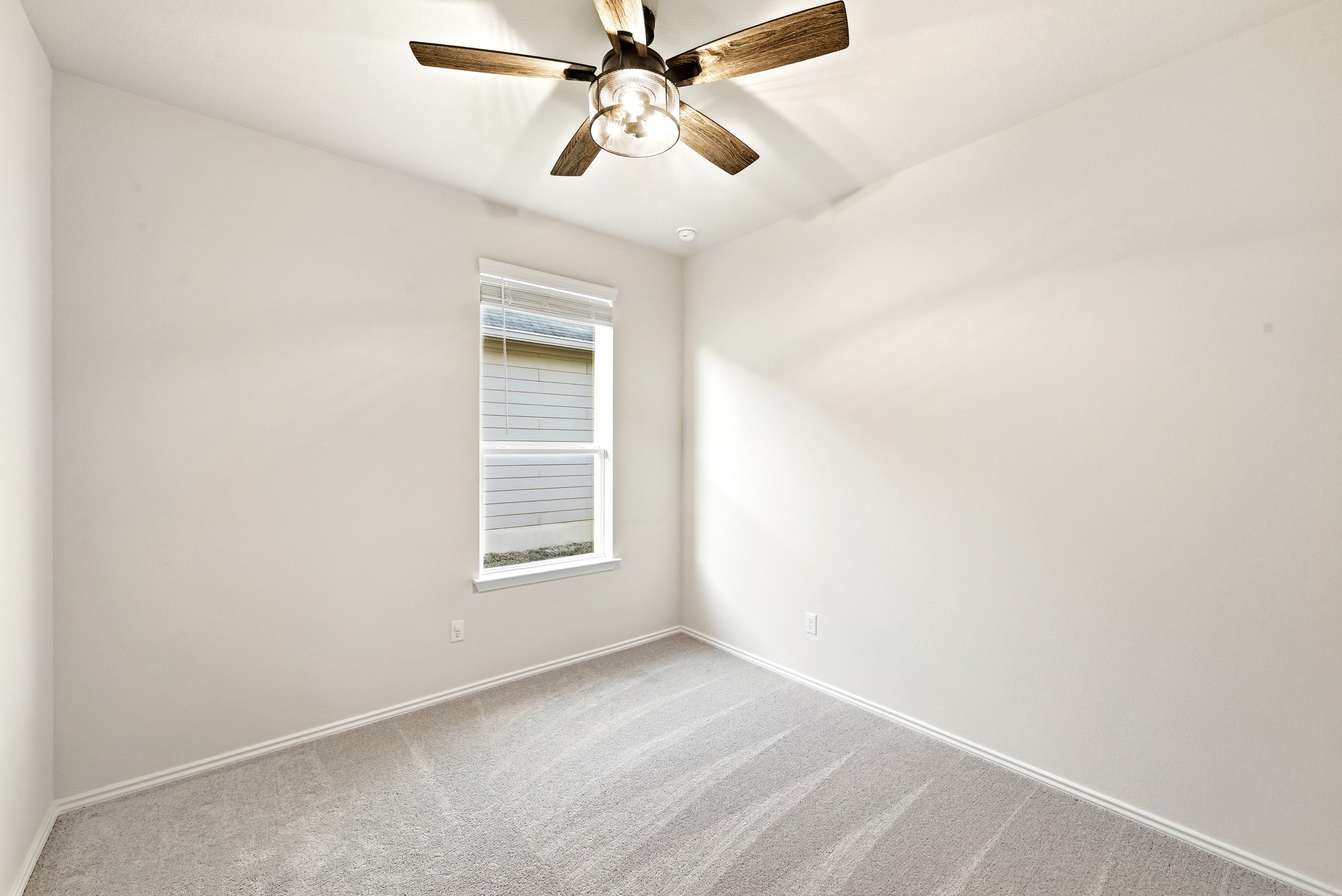 462 Tree Nut Loop Buda, TX 78610 - Photo 21 of 38 Each guest bedroom includes carpet flooring, a ceiling fan and neutral toned walls