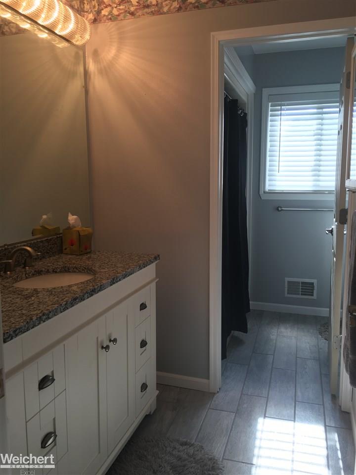 30505 Hayes Road Warren, MI 48088 - Photo 25 of 33 New light fixtures and new vanity with granite counter top and new flooring in the first floor bathroom
