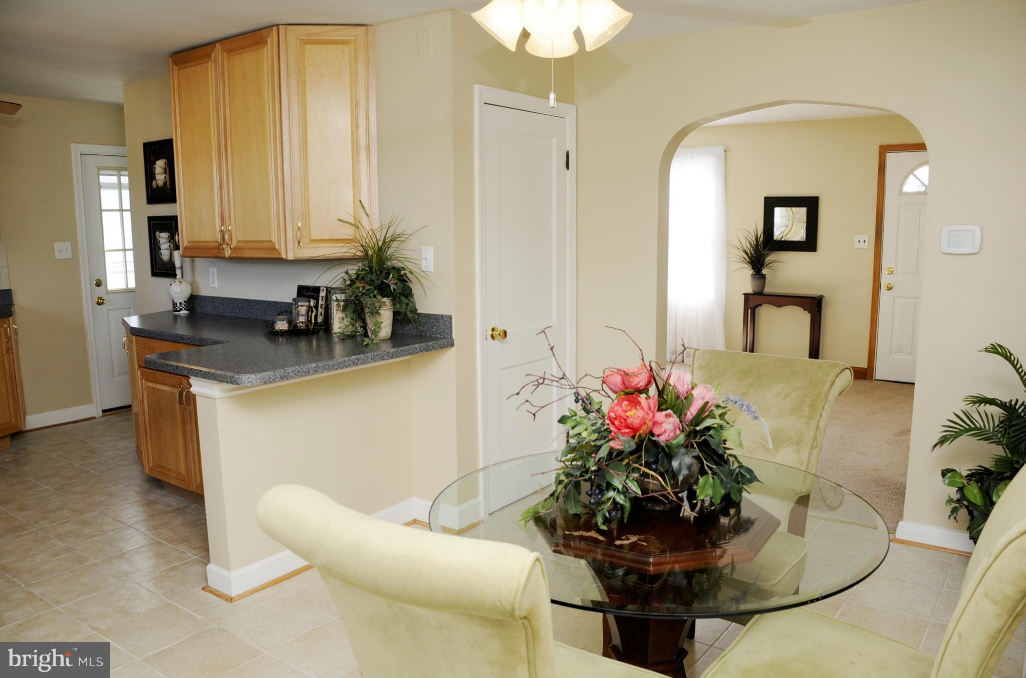 606 Cleveland Road Linthicum Heights, MD 21090 - Photo 1 of 24 a dining room with furniture and flowers