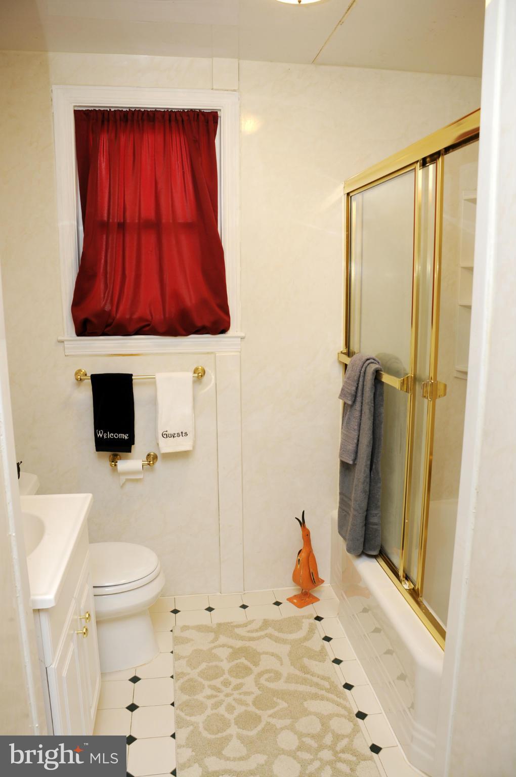 606 Cleveland Road Linthicum Heights, MD 21090 - Photo 12 of 24 a bathroom with a sink a toilet and shower