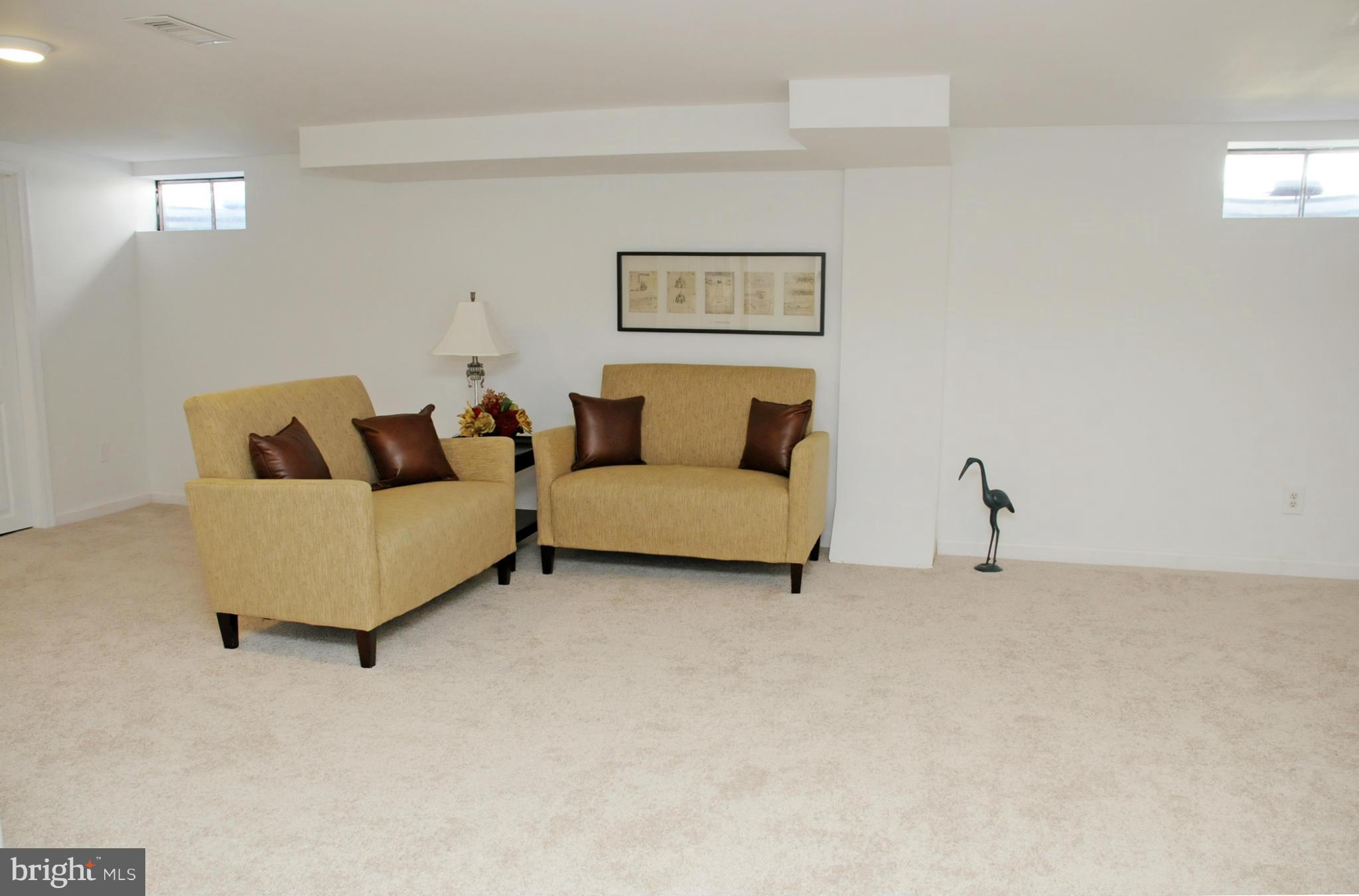 606 Cleveland Road Linthicum Heights, MD 21090 - Photo 16 of 24 a living room with furniture and a white wall next to a window