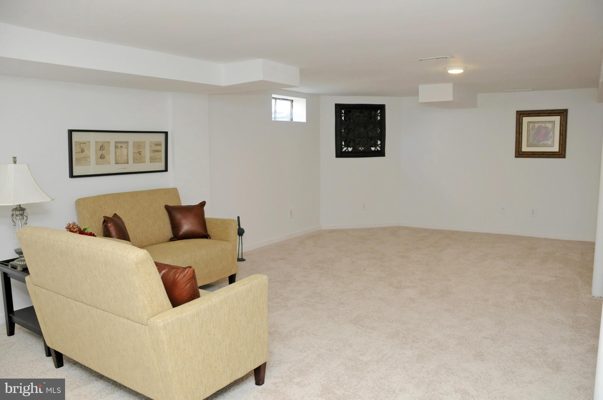 606 Cleveland Road Linthicum Heights, MD 21090 - Photo 18 of 24 a living room with furniture and a flat screen tv