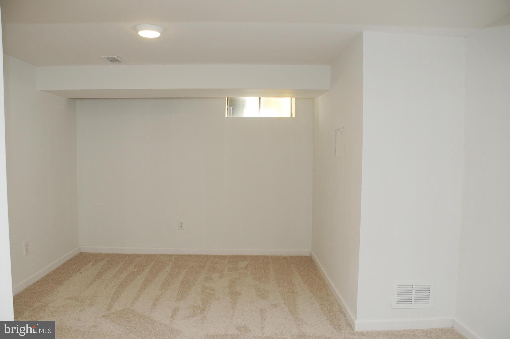 606 Cleveland Road Linthicum Heights, MD 21090 - Photo 19 of 24 a view of an empty room and window