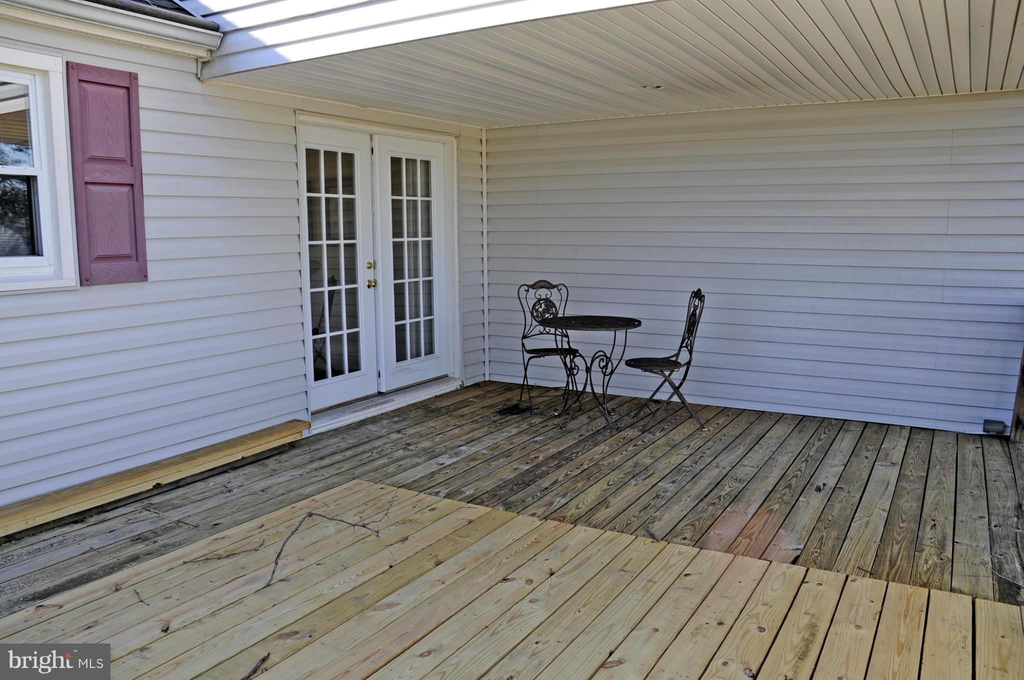 606 Cleveland Road Linthicum Heights, MD 21090 - Photo 23 of 24 a view of a roof deck with wooden floor and seating space