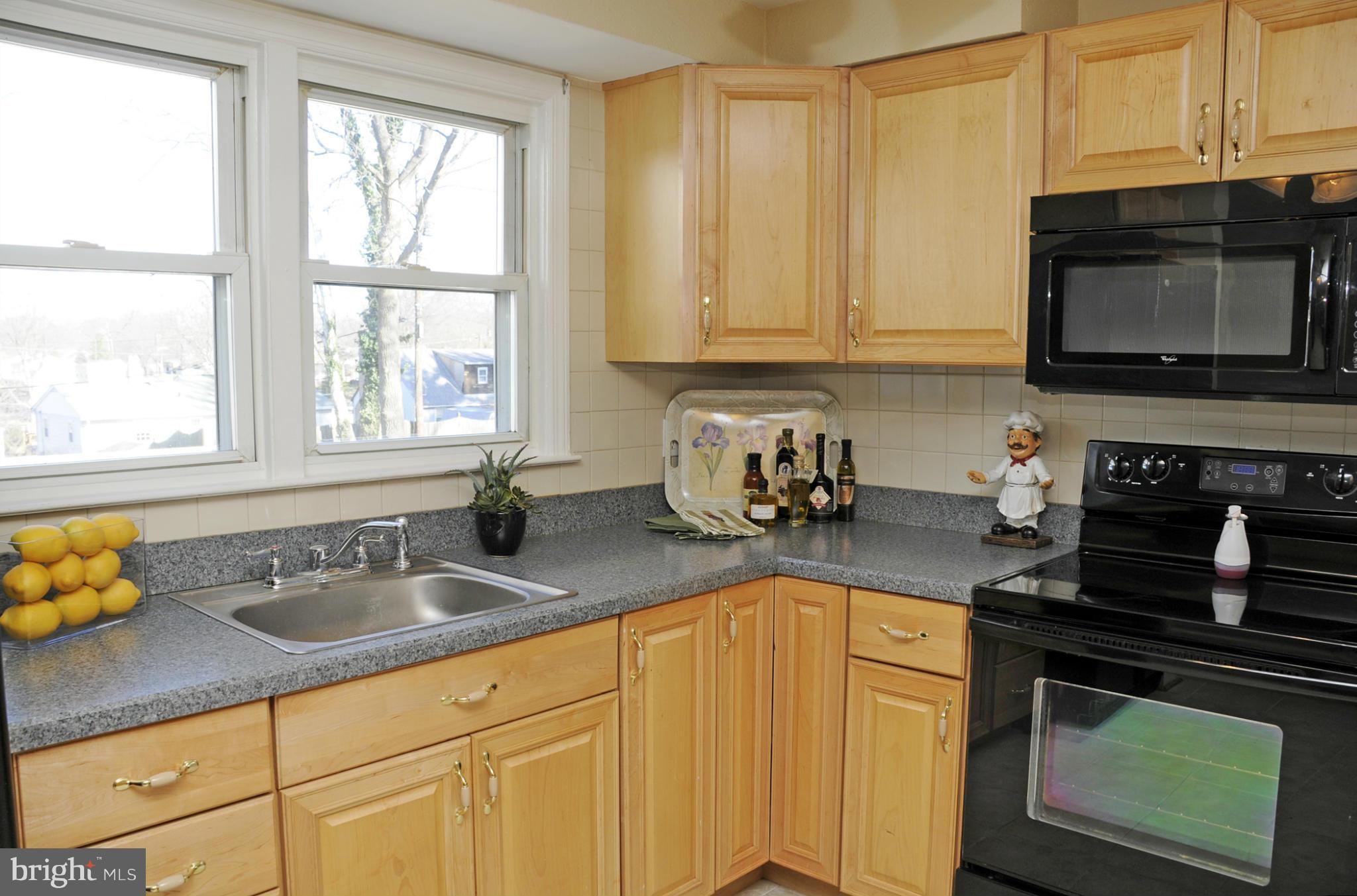 606 Cleveland Road Linthicum Heights, MD 21090 - Photo 6 of 24 a kitchen with stainless steel appliances granite countertop a sink stove and microwave
