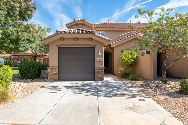 325 North Red Stone Road, Unit 191 Washington, UT 84780 - Photo 1 of 1 Mediterranean / spanish-style house with stucco siding, driveway, stone siding, a tiled roof, and an attached garage