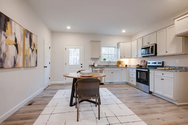 a kitchen with stainless steel appliances kitchen island granite countertop a sink and cabinets