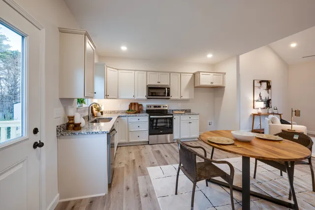 a kitchen with granite countertop counter space a sink appliances and cabinets