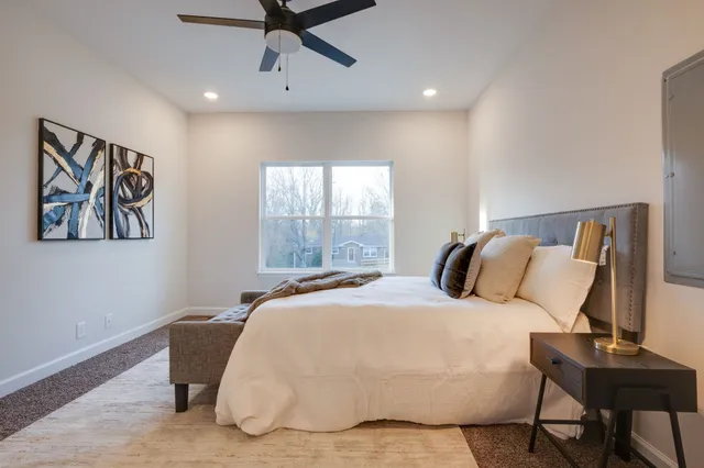 a bedroom with a bed and a window