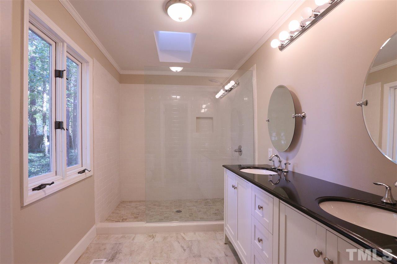 3109 Rutledge Court Raleigh, NC 27613 - Photo 11 of 25 a spacious bathroom with a double vanity sink a mirror and a shower