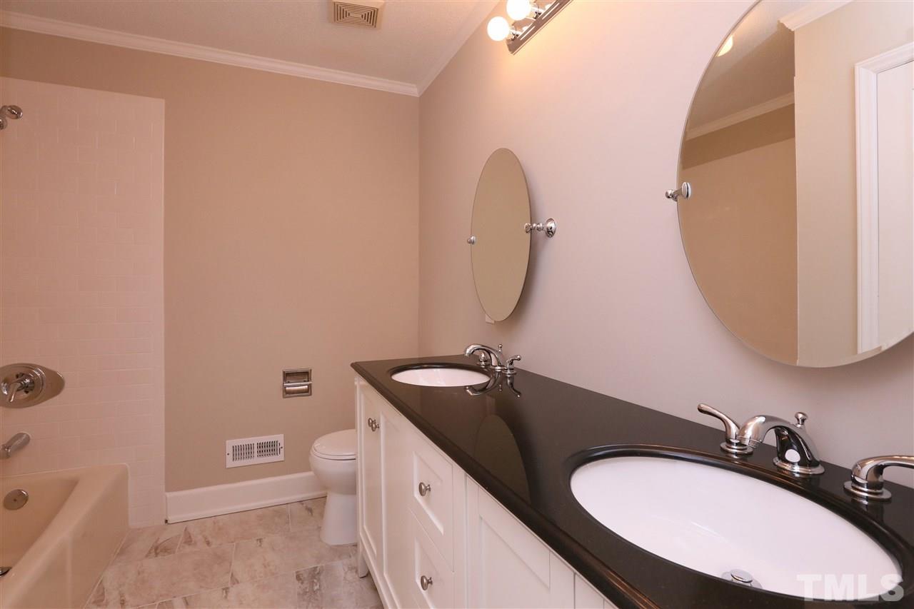 3109 Rutledge Court Raleigh, NC 27613 - Photo 14 of 25 a bathroom with a granite countertop sink toilet and mirror