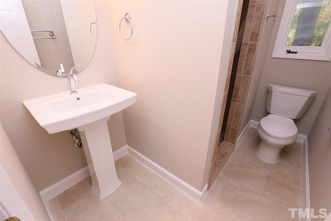 3109 Rutledge Court Raleigh, NC 27613 - Photo 16 of 25 a bathroom with a sink a toilet and mirror
