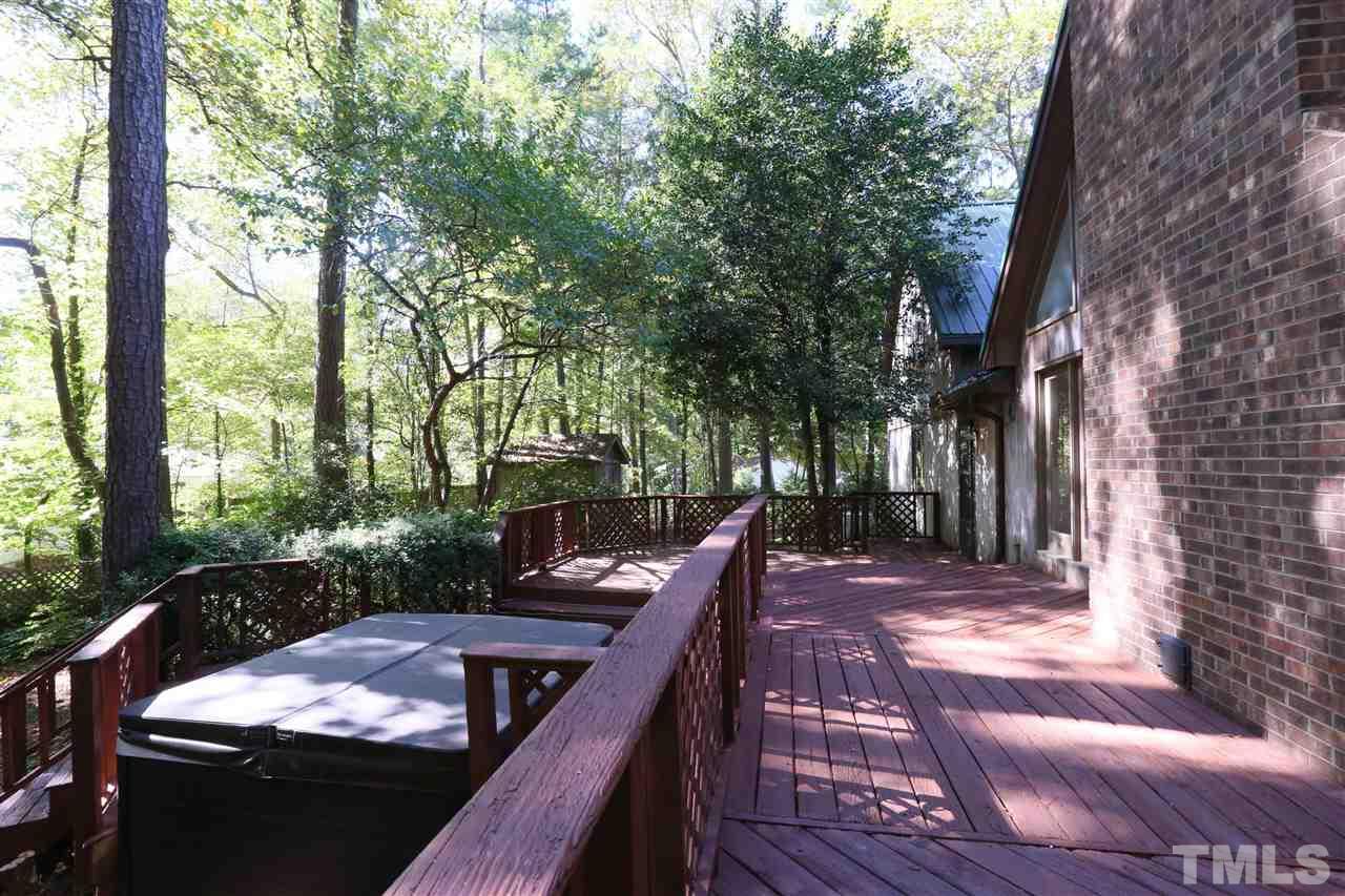 3109 Rutledge Court Raleigh, NC 27613 - Photo 21 of 25 a view of a roof deck with couches and wooden fence