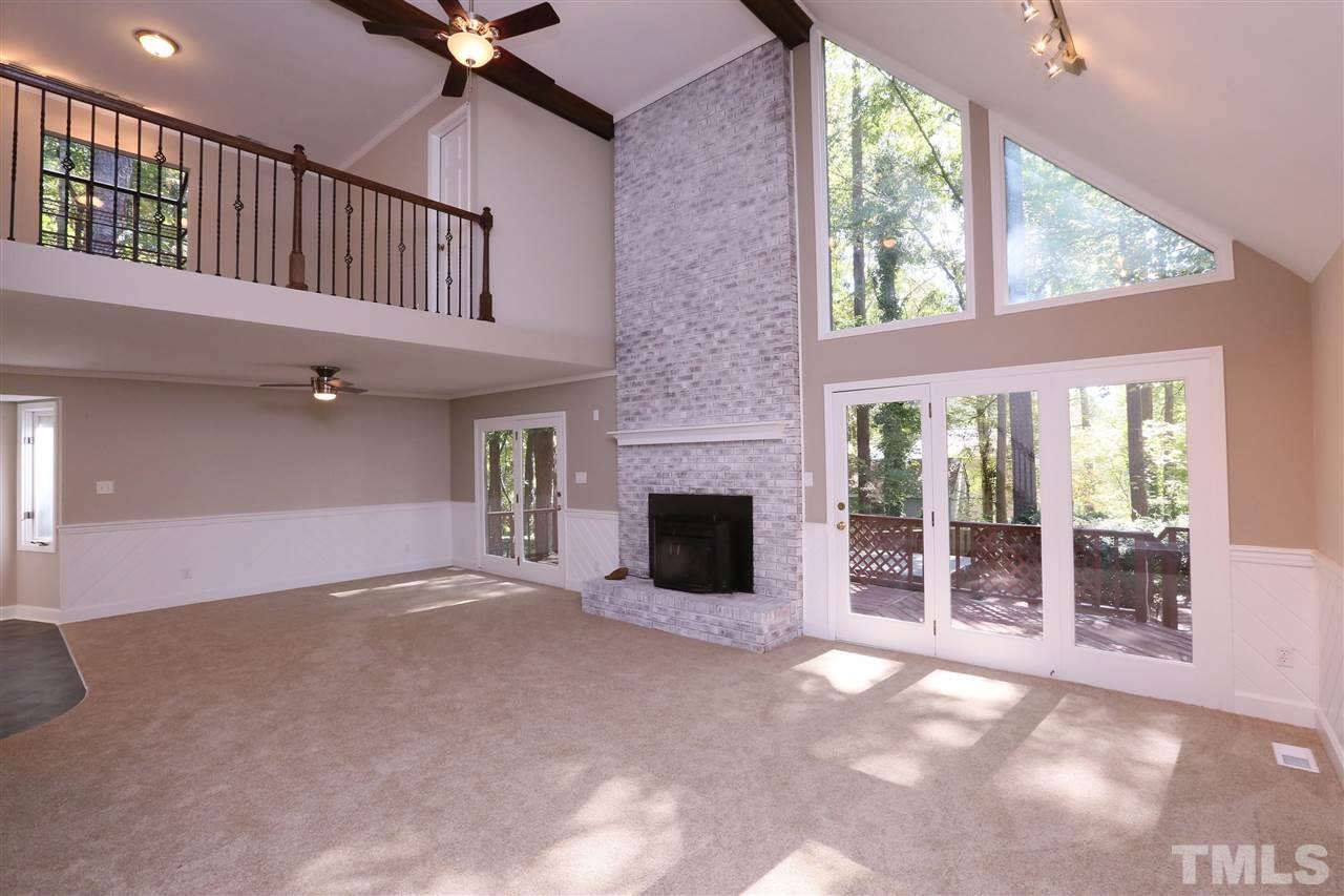 3109 Rutledge Court Raleigh, NC 27613 - Photo 4 of 25 a view of an empty room with a fireplace and windows