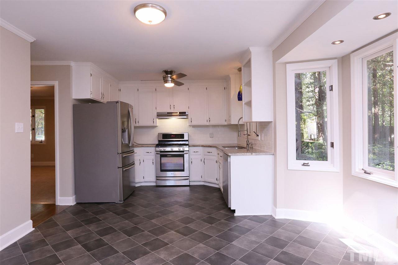3109 Rutledge Court Raleigh, NC 27613 - Photo 7 of 25 a kitchen with a refrigerator and a stove top oven