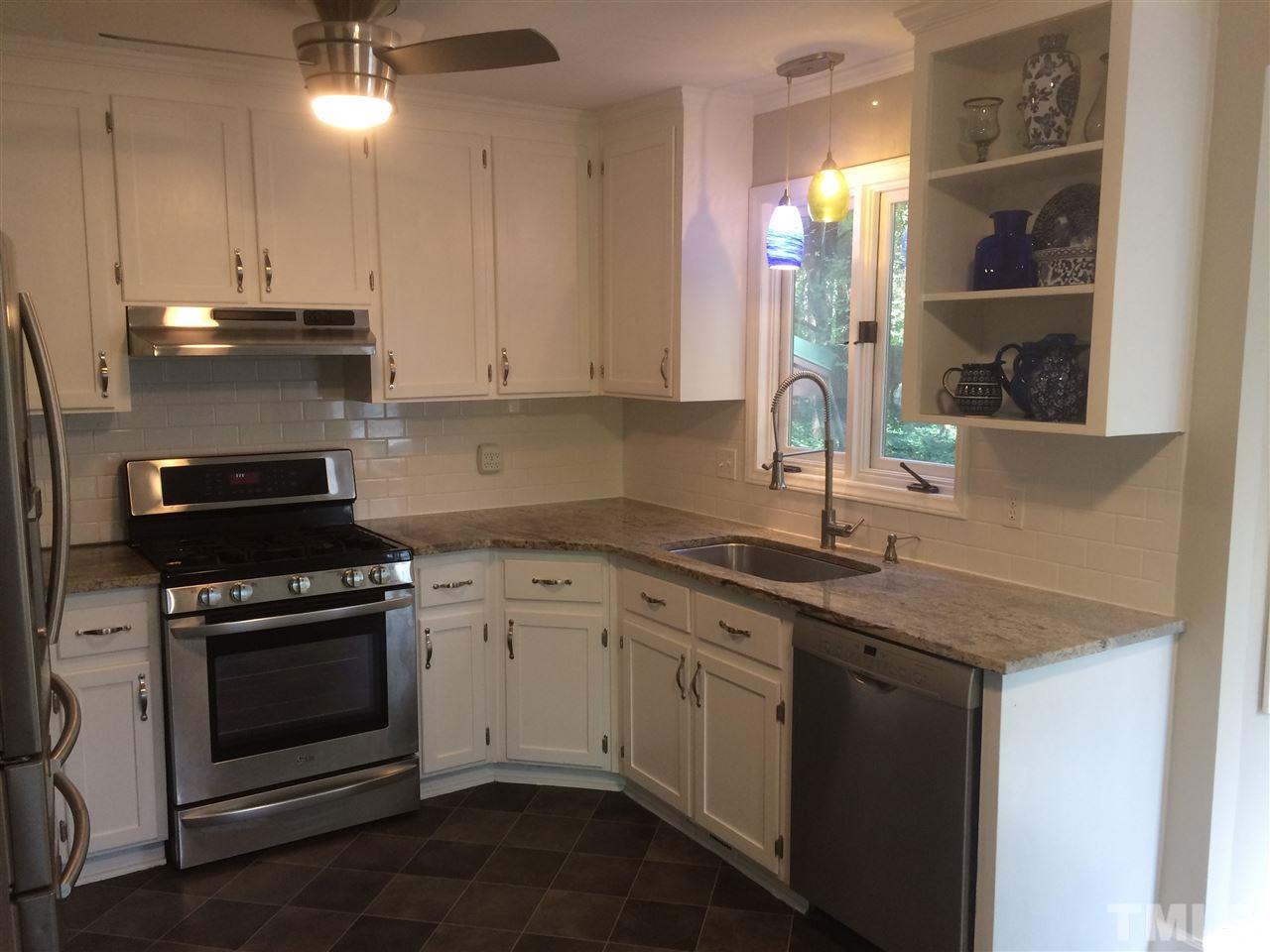 3109 Rutledge Court Raleigh, NC 27613 - Photo 9 of 25 a kitchen with a stove and white cabinets