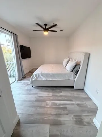 a bedroom with a bed and a television