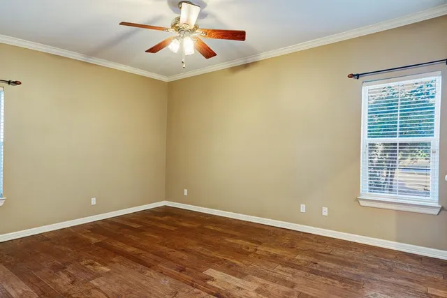 a view of a kitchen with fridge and wooden floor